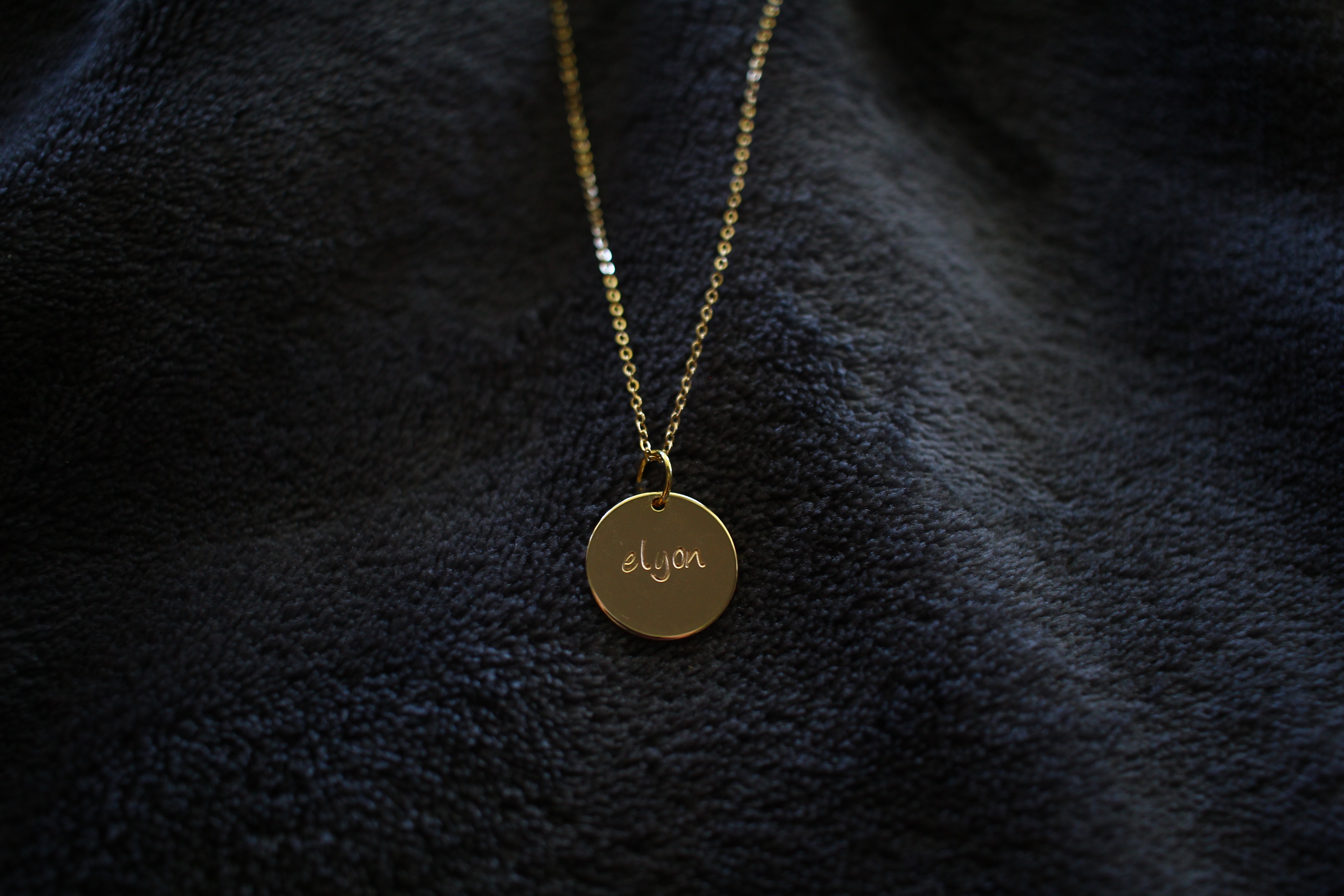 Gold necklace with 'Elyon' written on it