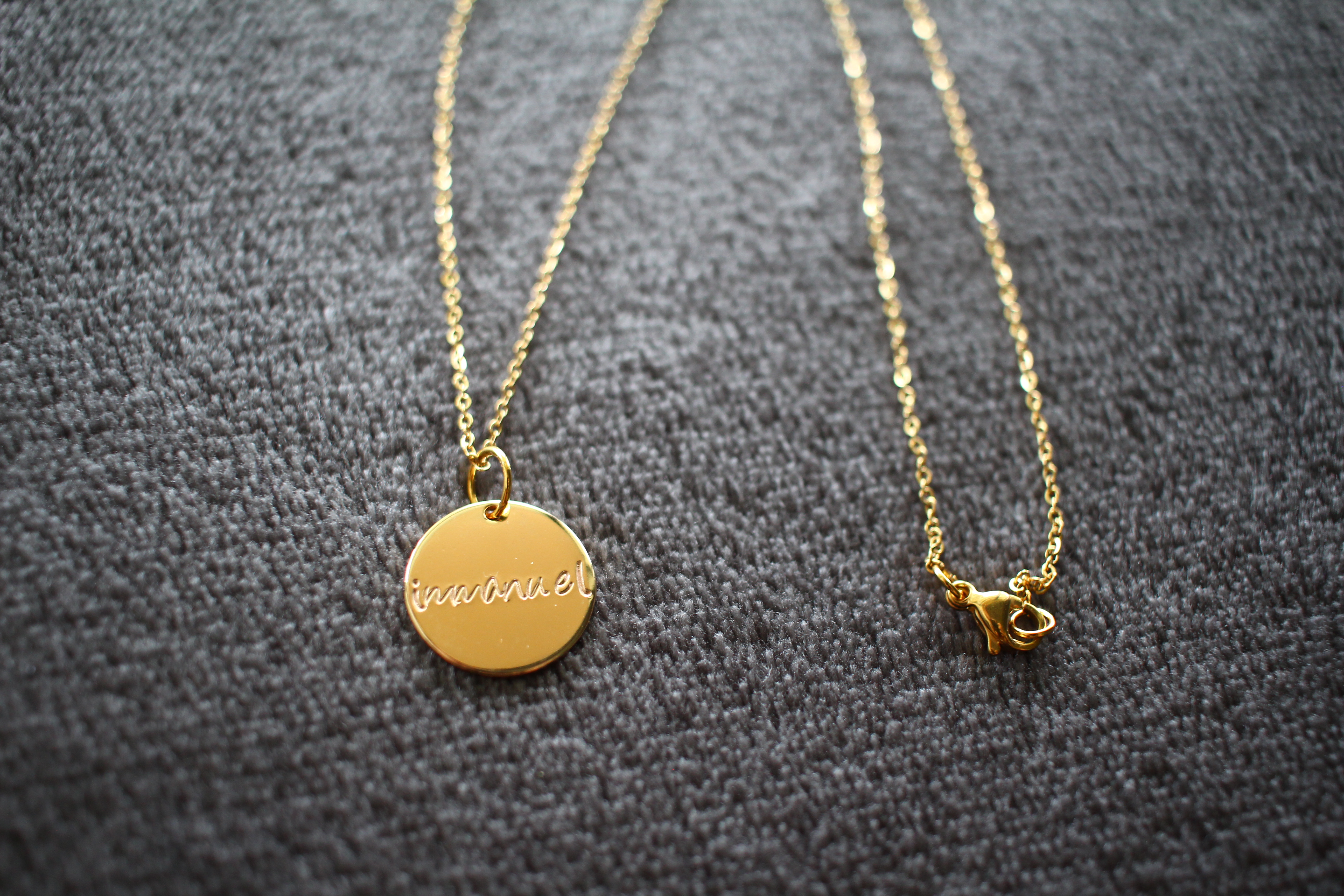 Gold necklace with 'Immanuel' written on it