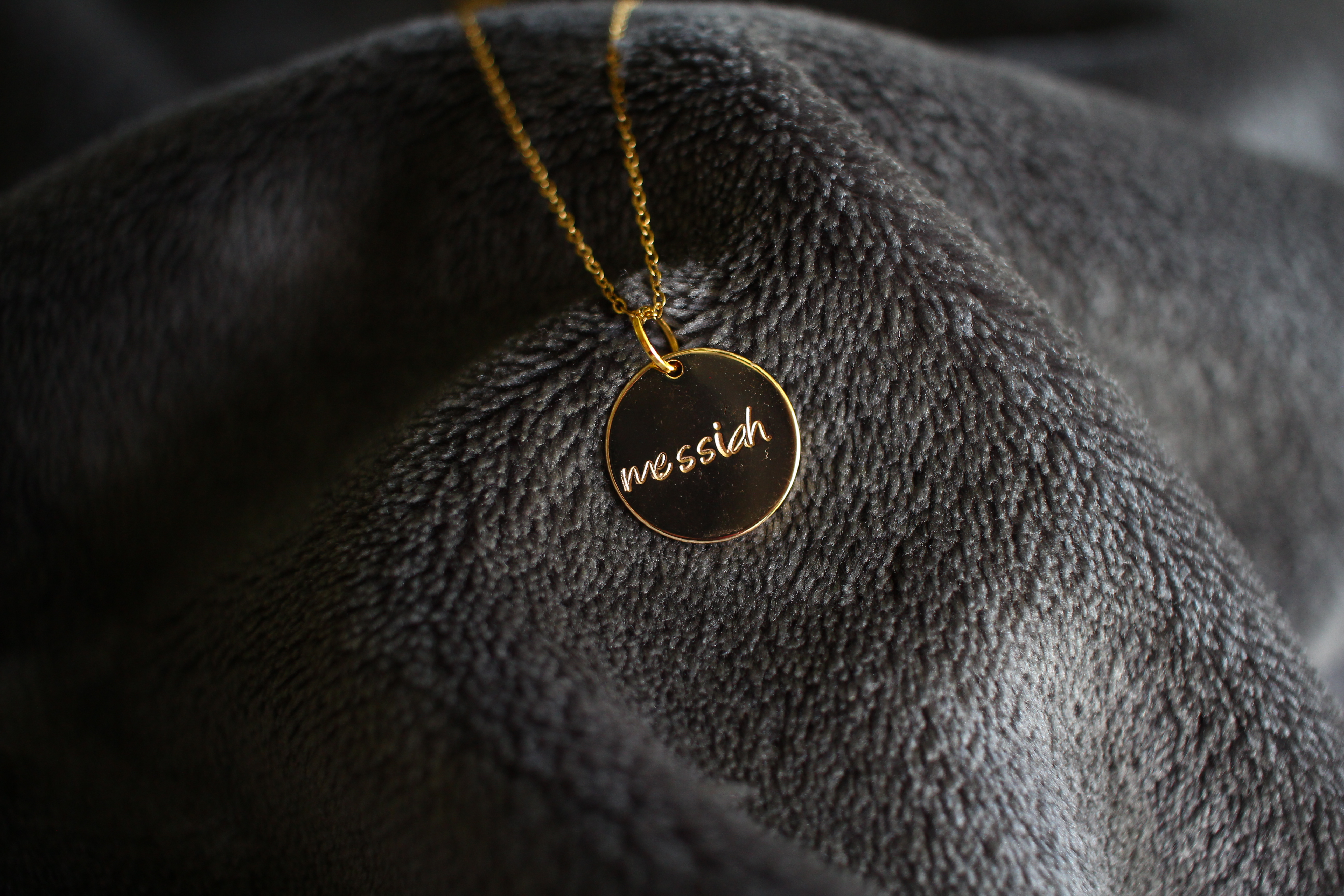 Gold necklace with 'Messiah' written on it