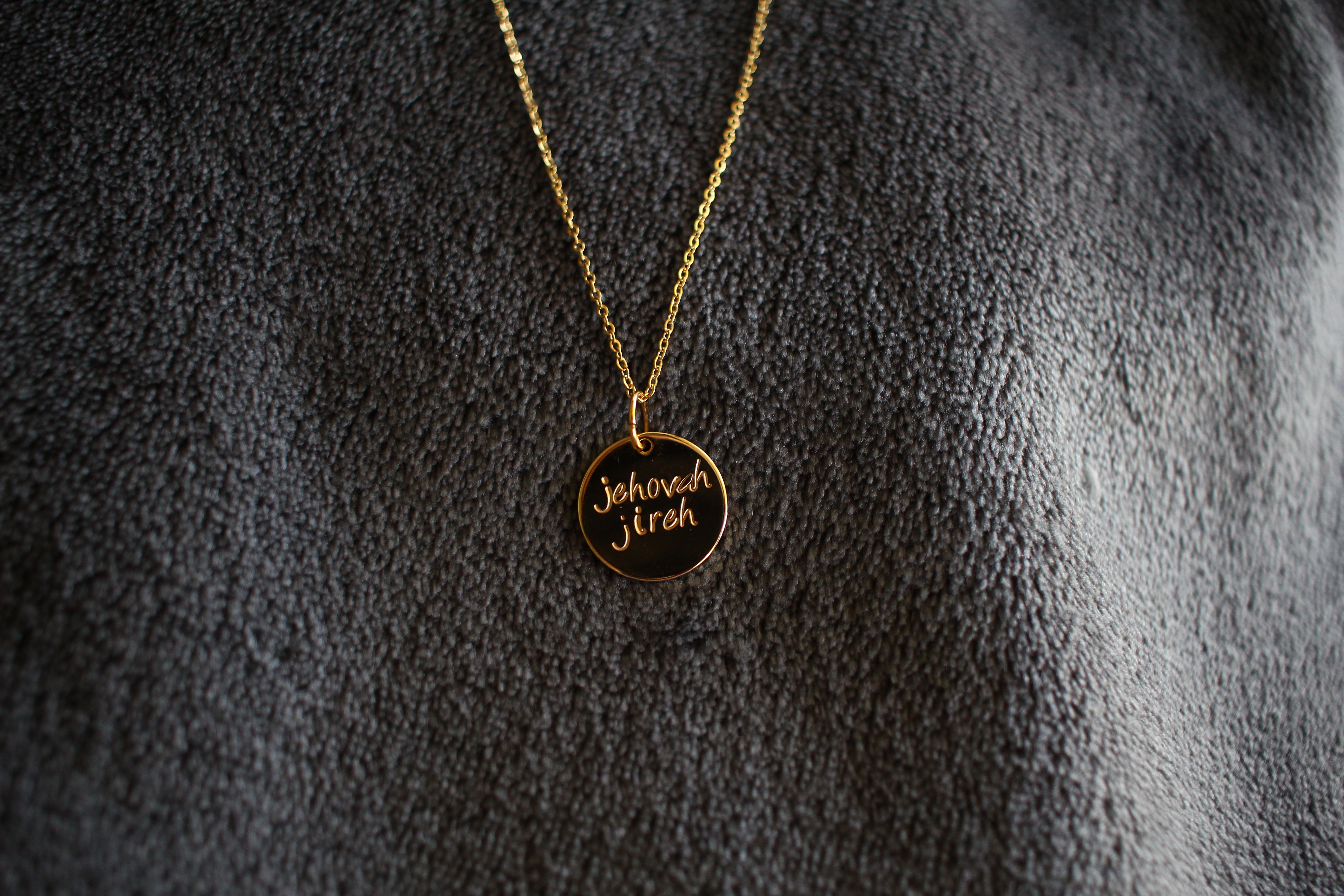 Gold necklace with 'Messiah' written on it